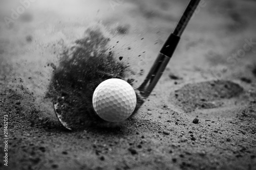 Golfers are hitting the golf ball by sand blasting