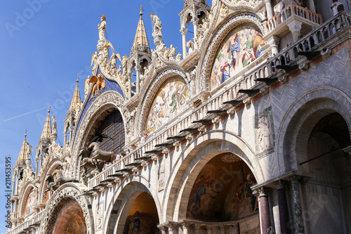 Famous amazing exterior of Saint Mark Basilica. Concept of last minute tours to Venice and landmarks of Italy. photo