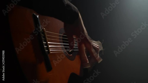 Man on the guitar plays the Latin rhythm. Close up
