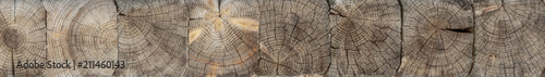 The logs are stacked horizontally. The texture of the transverse surface.