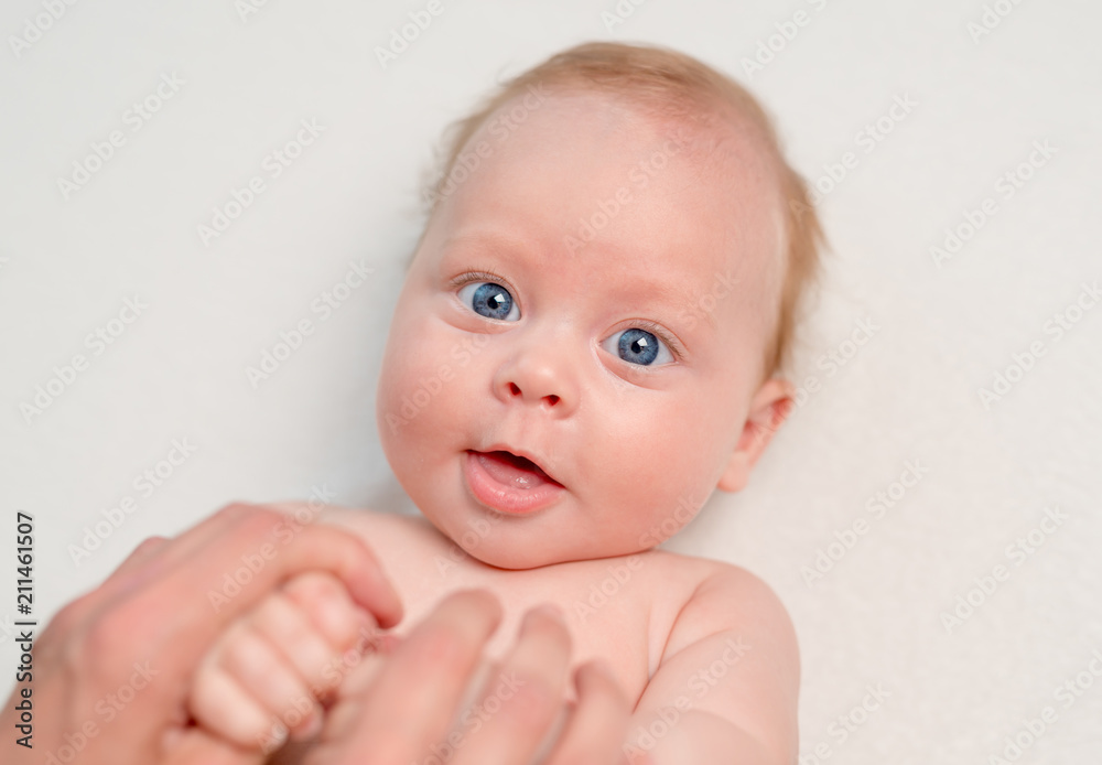 Mother doing body massage or gymnastics for newborn Mother doing body massage or gymnastics for newborn