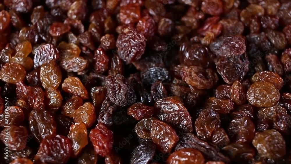 Raisins. Raisin grains rotating pattern macro texture background backdrop footage video.