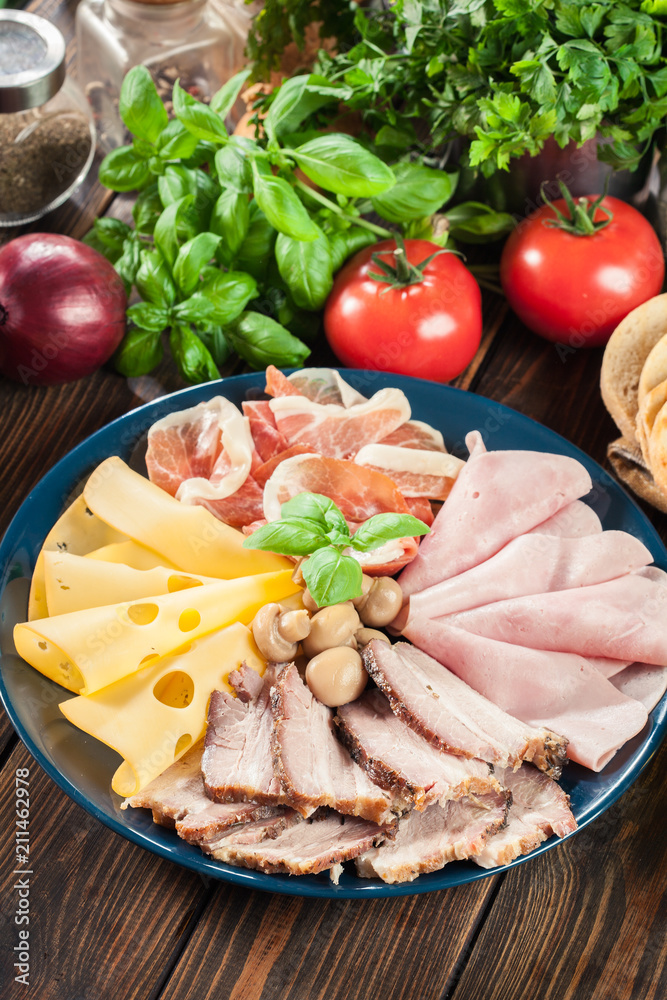 Cold meat platter with ham, prosciutto, bacon and cheese Cold meat platter with ham, prosciutto, bacon and cheese