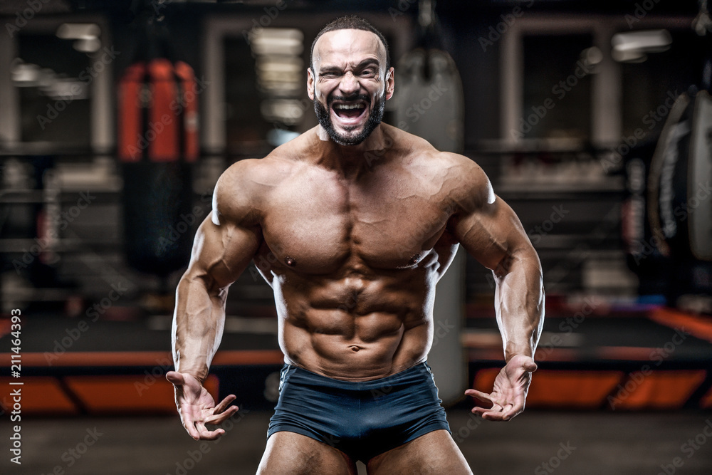 Fototapeta premium Brutal strong bodybuilder athletic men pumping up muscles with dumbbells