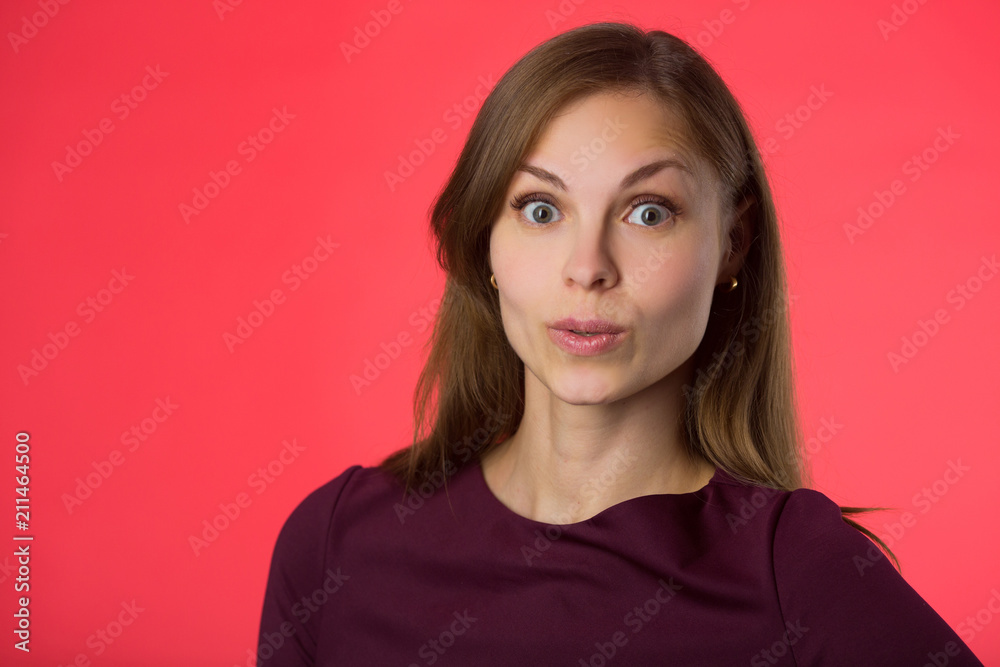 beautiful young girl with her hair on a red background beautiful young girl with her hair on a red background