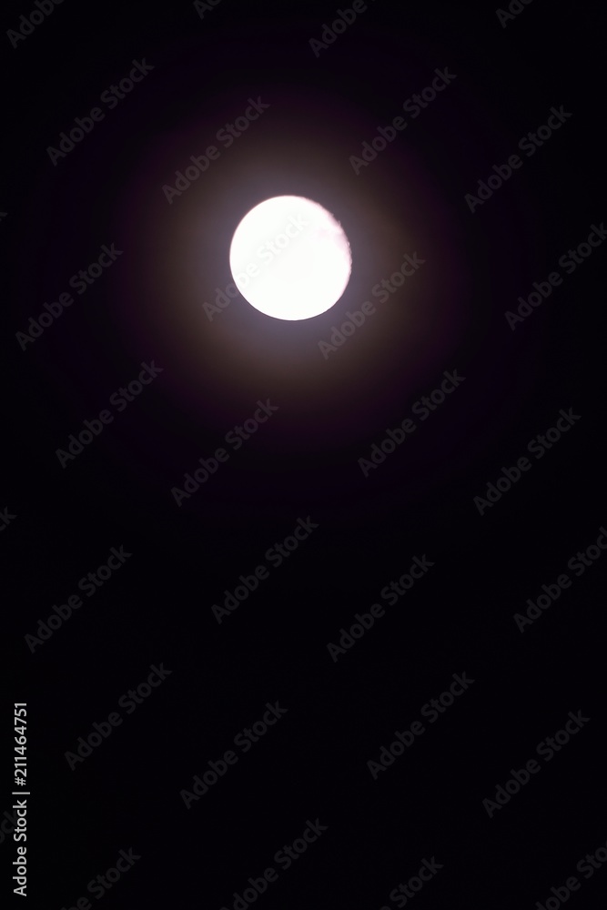 Nature background of shining full moon in dark night sky