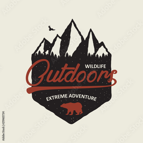 Outdoors adventure typography graphic for t-shirt. Vintage print with mountains, forest and bear. Tee shirt design for mountain explore theme, hiking. Vector illustration.