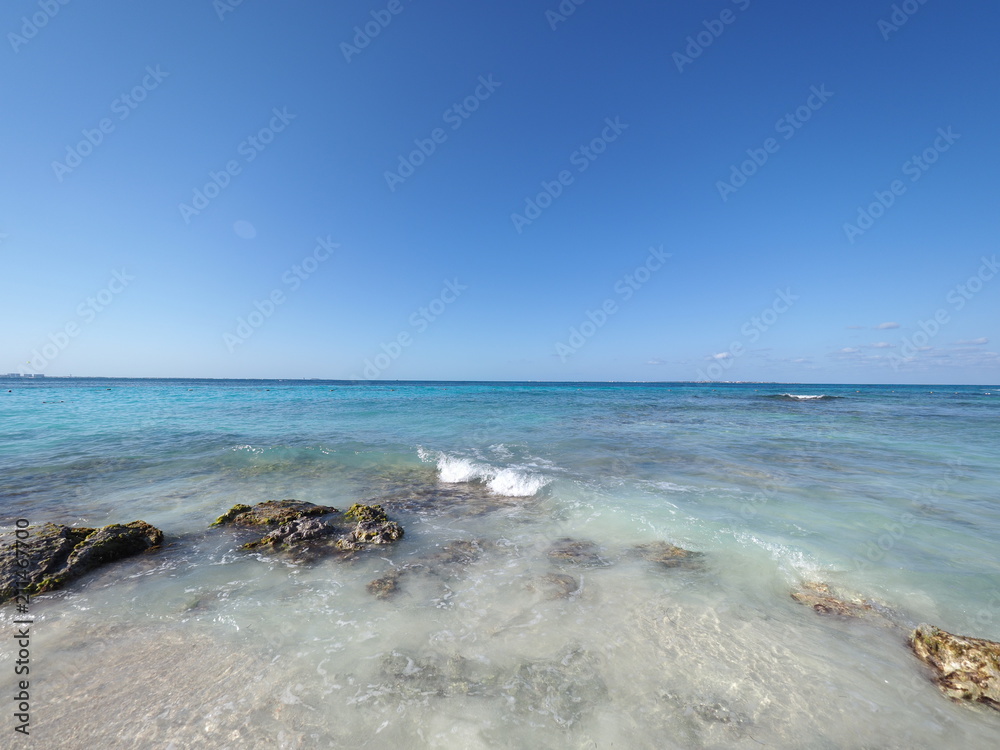 Seascape panoramic view of turquoise waters of Caribbean Sea landscape with horizon line at Cancun city in Mexico