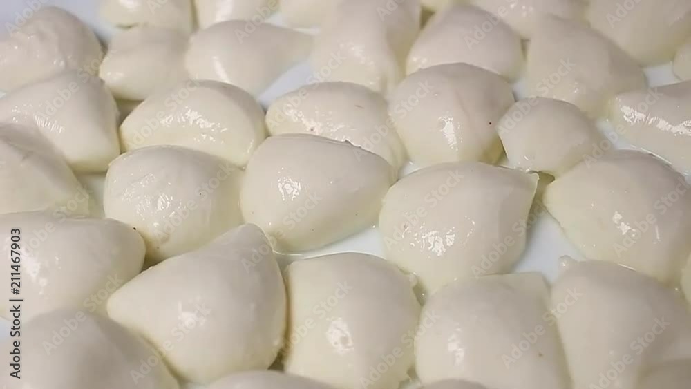 Mozzarella cheese balls rotating pattern macro texture background backdrop footage video. Mozzarella cheese balls rotating pattern macro texture background backdrop footage video.