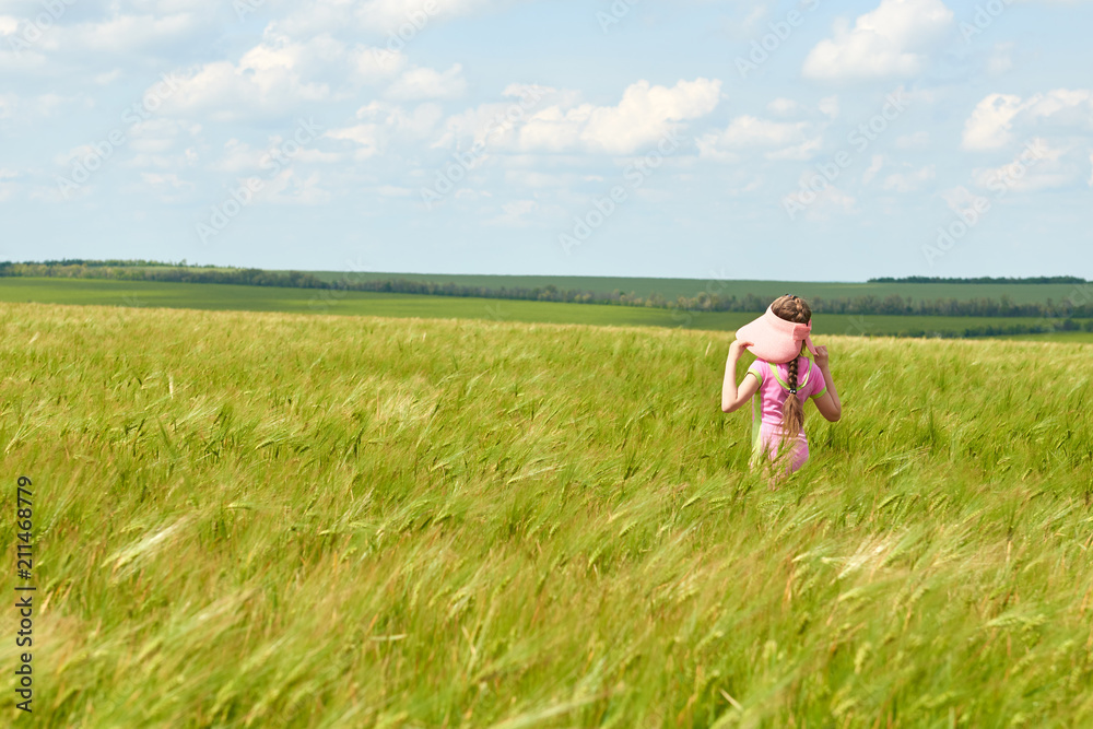 child walking through the wheat field, bright sun, beautiful summer landscape child walking through the wheat field, bright sun, beautiful summer landscape