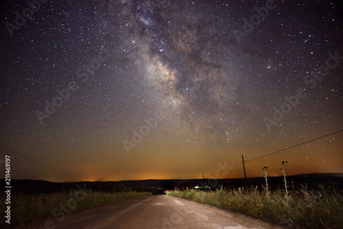 Road landscape with Milky Way galaxy in the sky.
