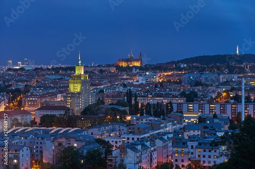 Landscape or cityscape Picture of Prague, during the sunset or in blue hour shows contrast between communist style hotel building and Saint Vitus cathedral.   © jdmfoto