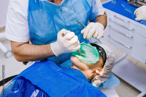 Close-up of teeth patient using cofferdam
