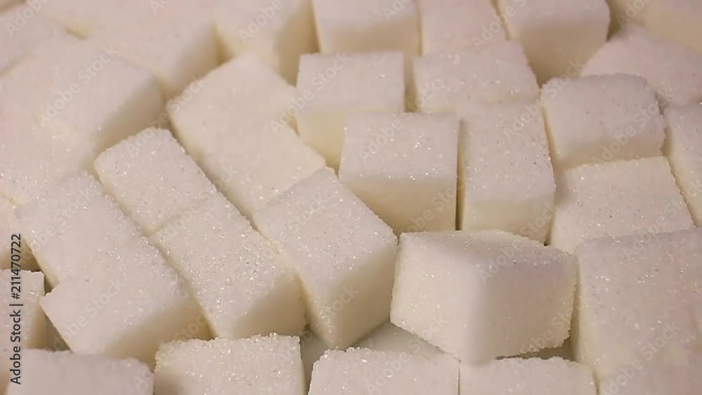 White sugar cubes. Lump sugar cube rotating pattern macro texture background backdrop footage video. White sugar cubes. Lump sugar cube rotating pattern macro texture background backdrop footage video.