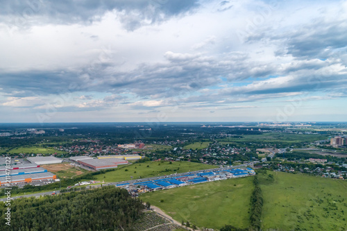 Aerial view of wheat fields, meadow, forest and village in rural Russia. © nordroden