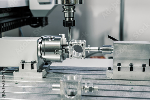 Precision milling CNC machine tool makes part.