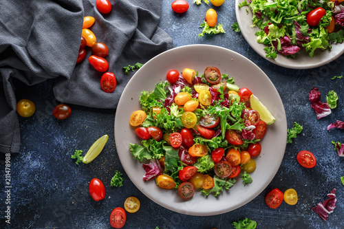 Fresh Cherry Tomato mix salad with lettuce, lemon, lime, black pepper and sea salt. healthy food