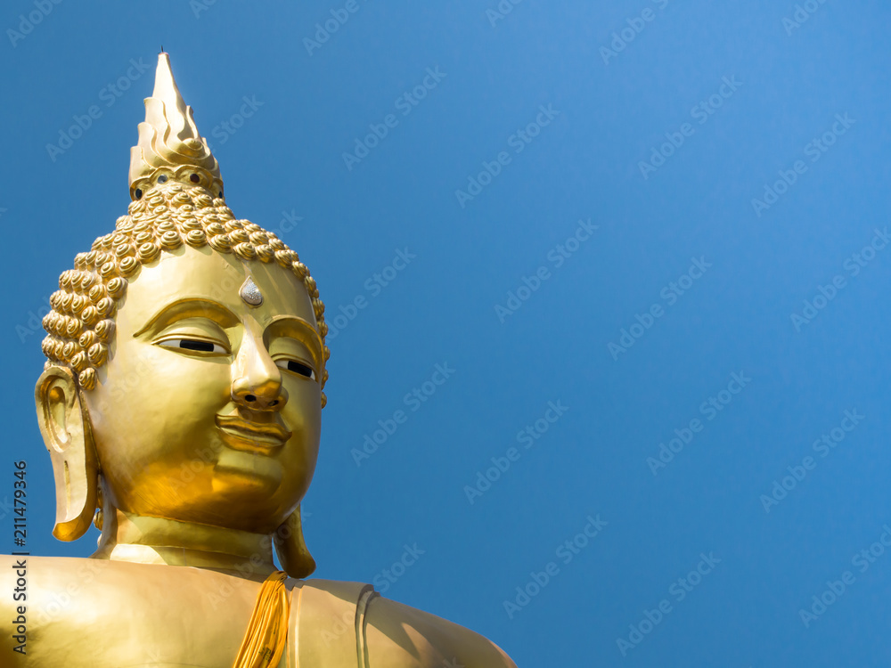 the part of big gold buddha on blue sky background in Thailand