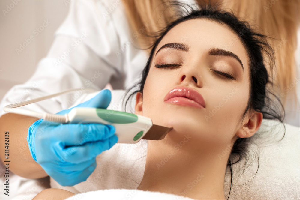Beautician makes cleaning of face in spa salon. Beautician makes cleaning of face in spa salon.