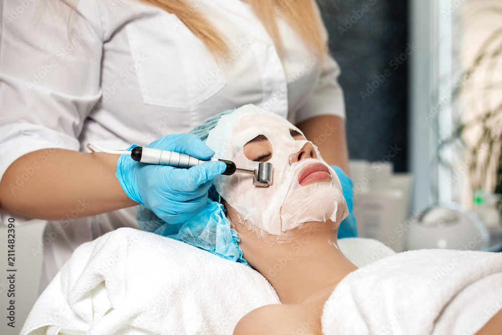 beautician applies face mask on woman beautician applies face mask on woman