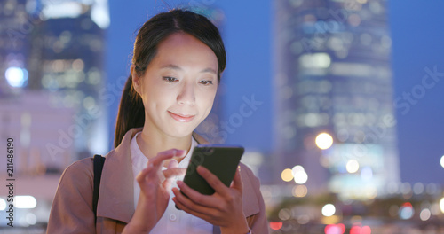 Young business woman use of smart phone at night