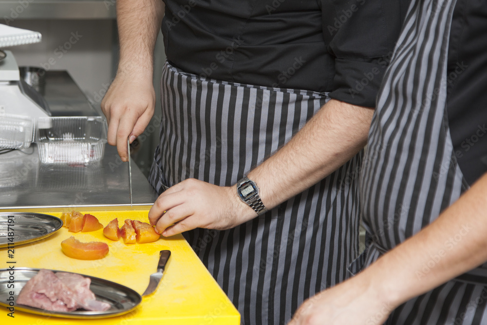 Hands chef preparing a dish of peaches Hands chef preparing a dish of peaches