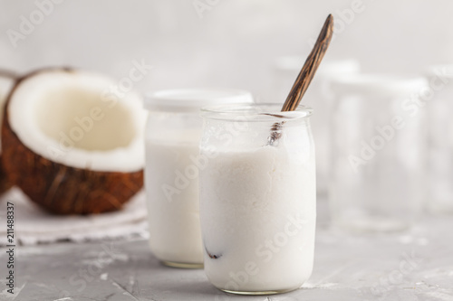 Preparation of homemade coconut yogurt in jars. Healthy alternative vegan food concept.