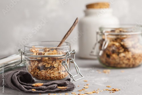 Homemade oat granola in glass jars. Healthy food concept.