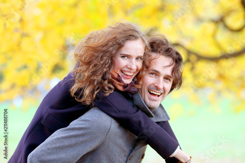 Couple having fun in autumn park