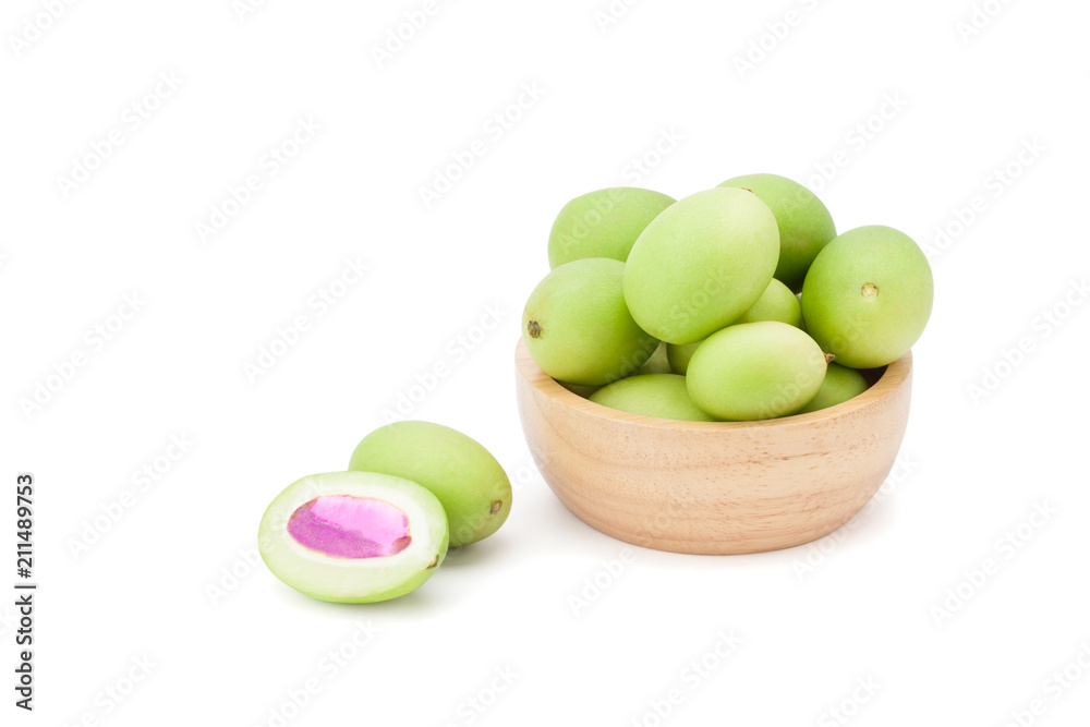 Plum Mango or Marian Plum fruits (Bouea macrophylla Griffith) in wooden bowl Plum Mango or Marian Plum fruits (Bouea macrophylla Griffith) in wooden bowl