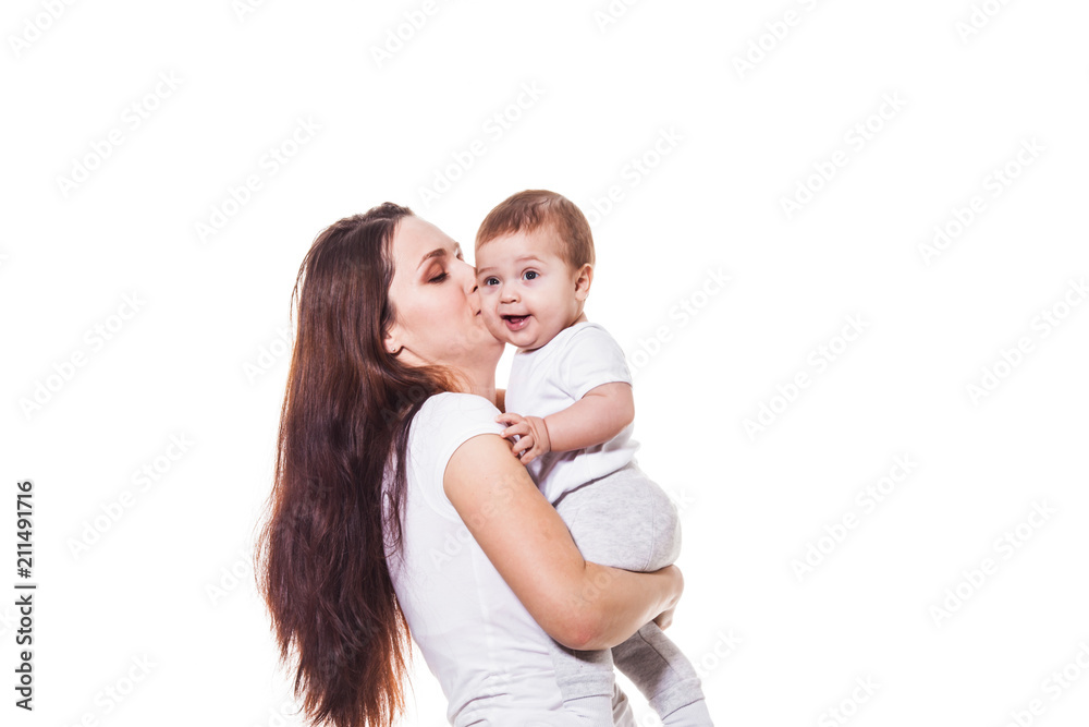 Beautiful young mother kisses her child Beautiful young mother kisses her child