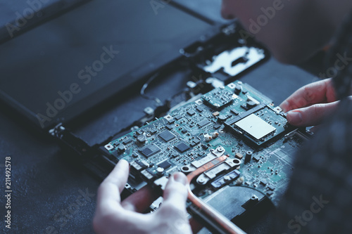 computer hardware development. microelectronics technology science concept. engineer holding modern motherboard photo