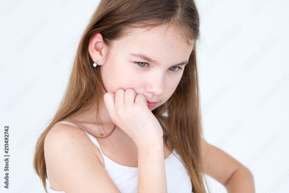 emotion face. pensive thoughtful serious child. hand under the chin. little girl portrait on white background. mood feelings personality and facial expression concept emotion face. pensive thoughtful serious child. hand under the chin. little girl portrait on white background. mood feelings personality and facial expression concept