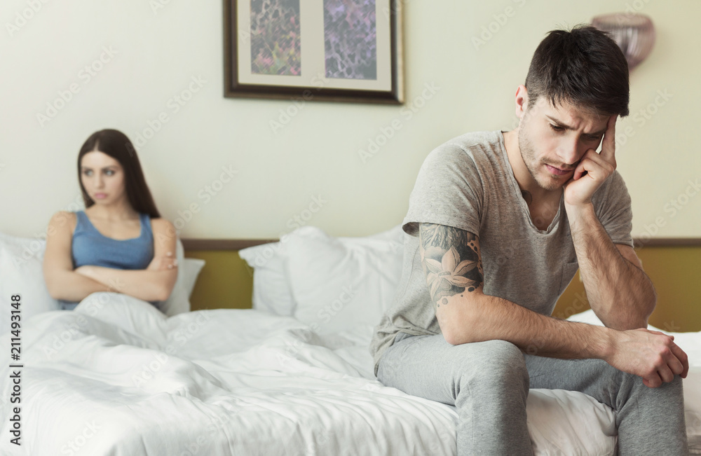 Unhappy man sitting in the bed Unhappy man sitting in the bed