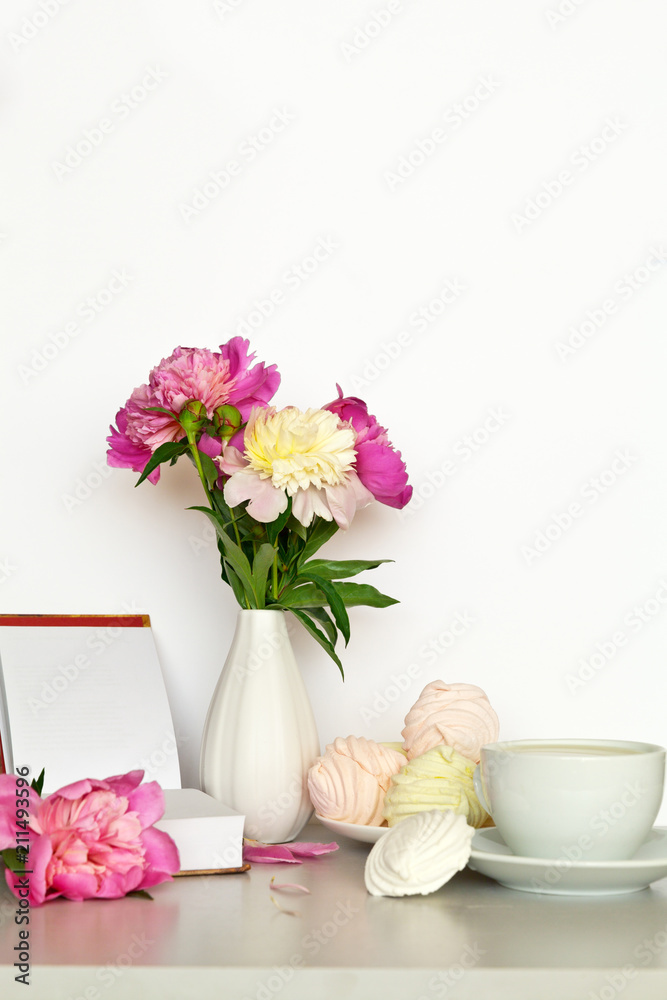 Still life with a bouquet of pink peonies and a sweet vanilla zefirs. Free space for text Still life with a bouquet of pink peonies and a sweet vanilla zefirs. Free space for text