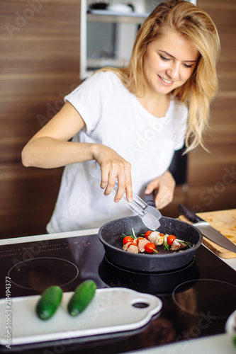 young Woman Cooking in the kitchen. Healthy Food. Dieting Concept. Healthy Lifestyle. Cooking At Home. Prepare Food photo