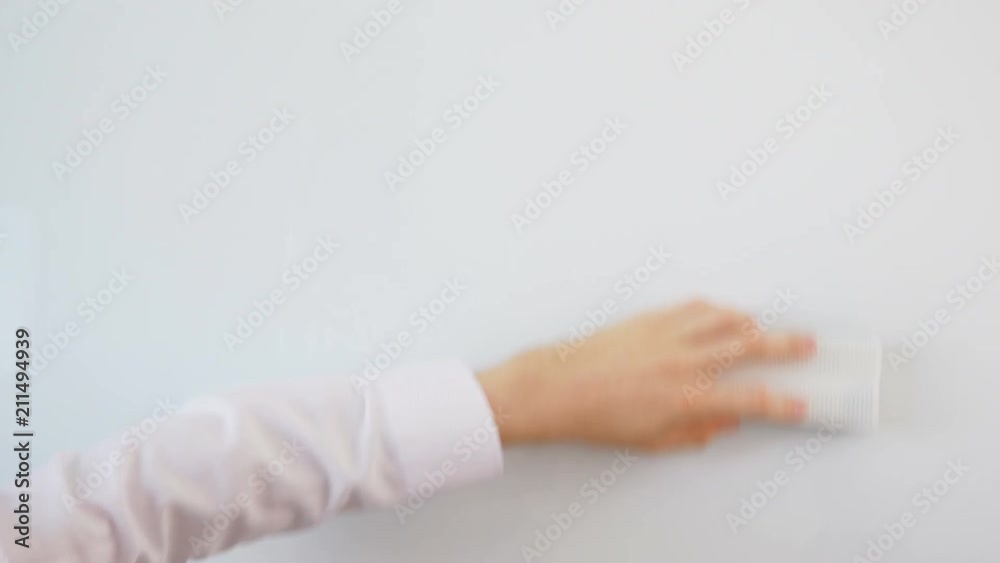 Learning. Man cleans Whiteboard in white shirt. Video for outro or intro creation.