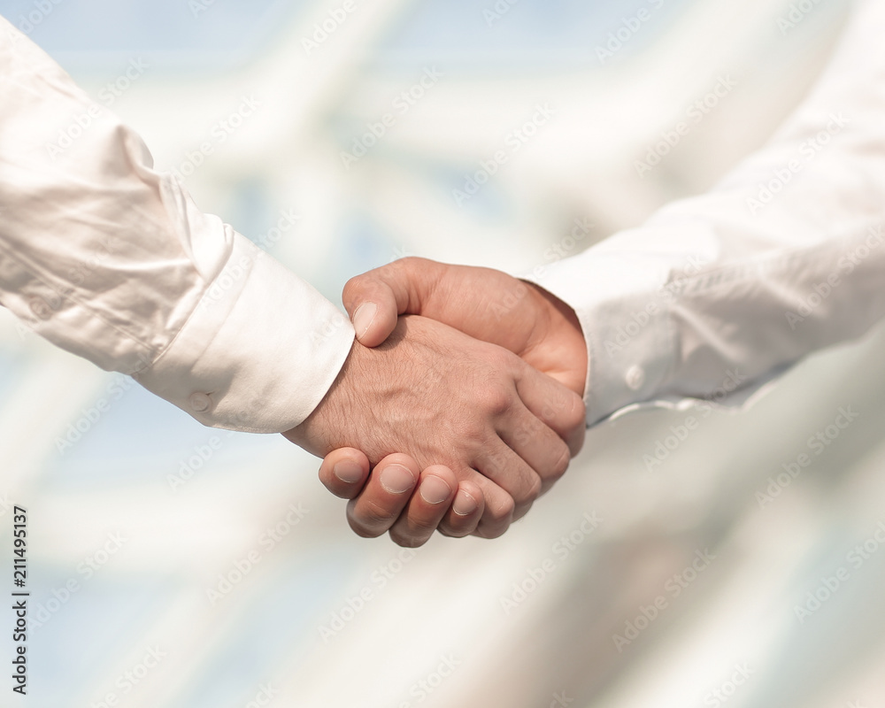 Close-up photo of handshake of two successful businessmen Close-up photo of handshake of two successful businessmen
