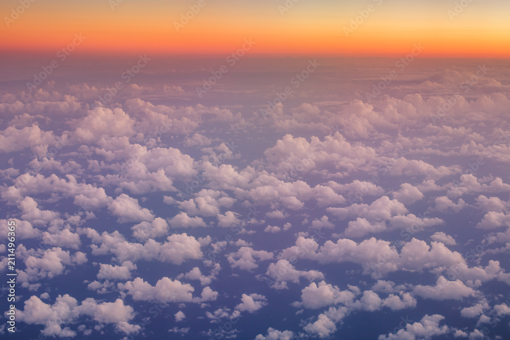Fototapeta premium Flying above the clouds. Aerial view from the airplane