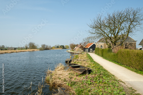 A polder canal with an old polder pumping station at there right photo