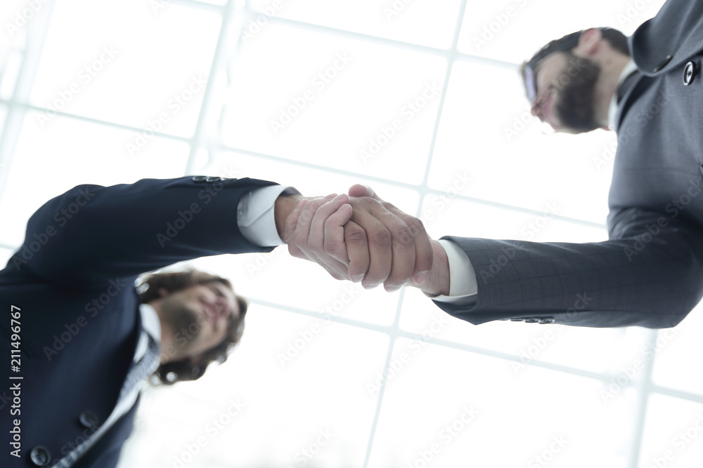 Two business people are holding hands to business cooperation.