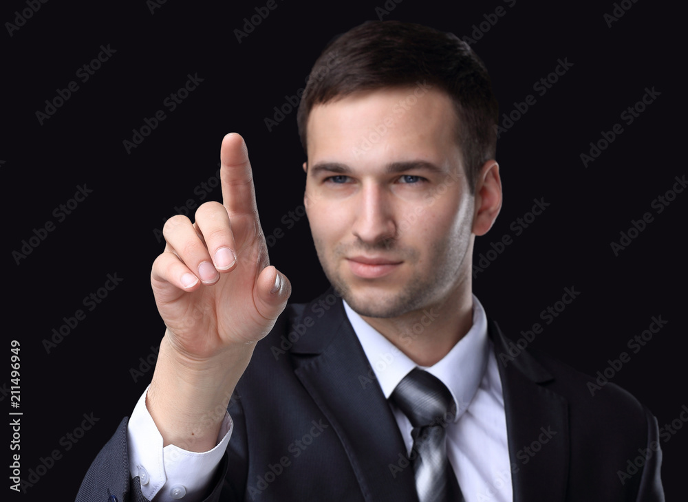 businessman pointing to a blank spot.isolated on a black background. businessman pointing to a blank spot.isolated on a black background.