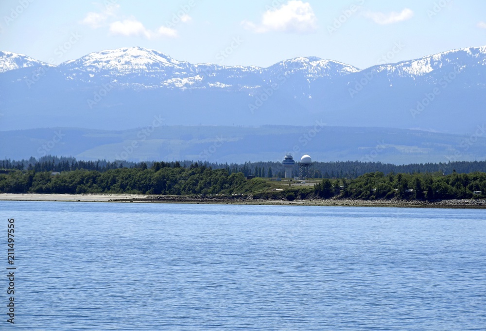 scenic view along the shoreline in near Comox with view of the Comox airport tower and the Strathcona Mountain range in the background, Vancouver Island British Columbia Canada scenic view along the shoreline in near Comox with view of the Comox airport tower and the Strathcona Mountain range in the background, Vancouver Island British Columbia Canada