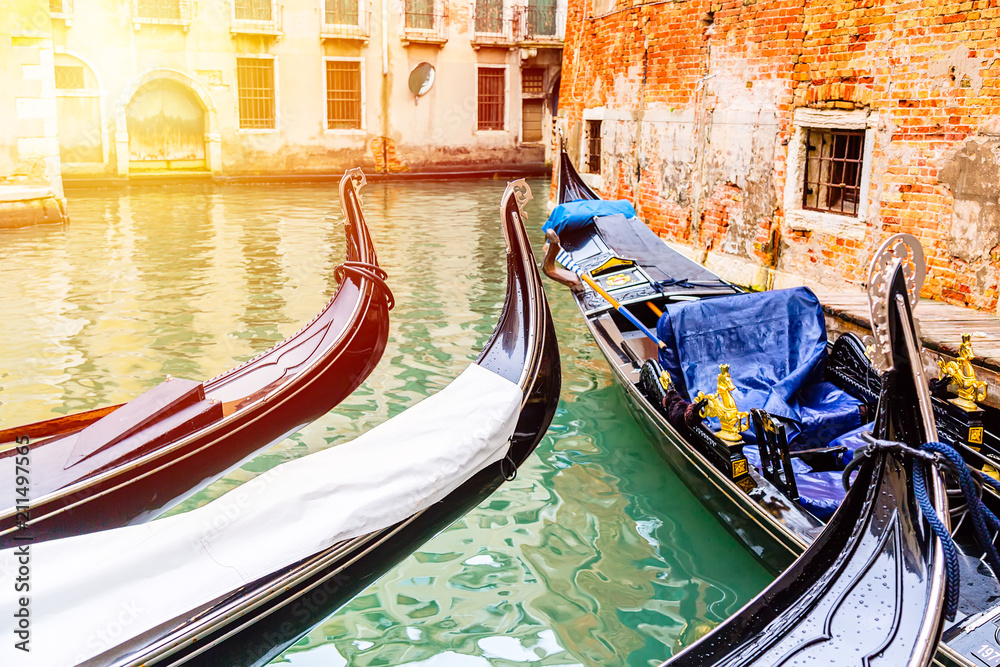 Canal with gondolas in Venice, Italy during sunrise. Tourism concept in Europe