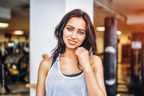 Portrait of sporty pretty smiling girl in the gym