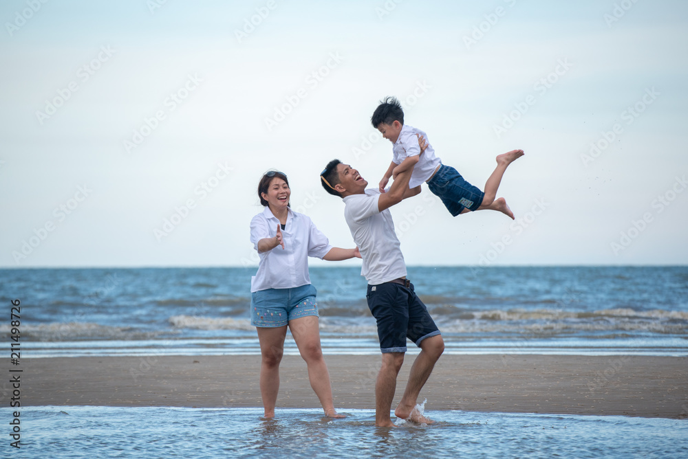 Happy family on the beach. Parents with Children enjoying a holiday at the sea. Summer vacation concept