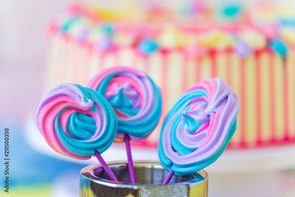 Lollipops Spiral Forms candy on pink background. Funny concept. Meringue candy on paper stick. Festive sweet table for children. Candy Bar. Cake as a background