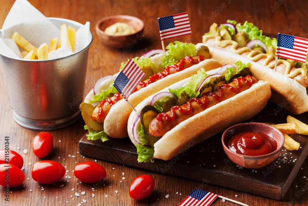 Fast food from hot dog with sausage and fries decorated USA flag on 4th july. Table setting on