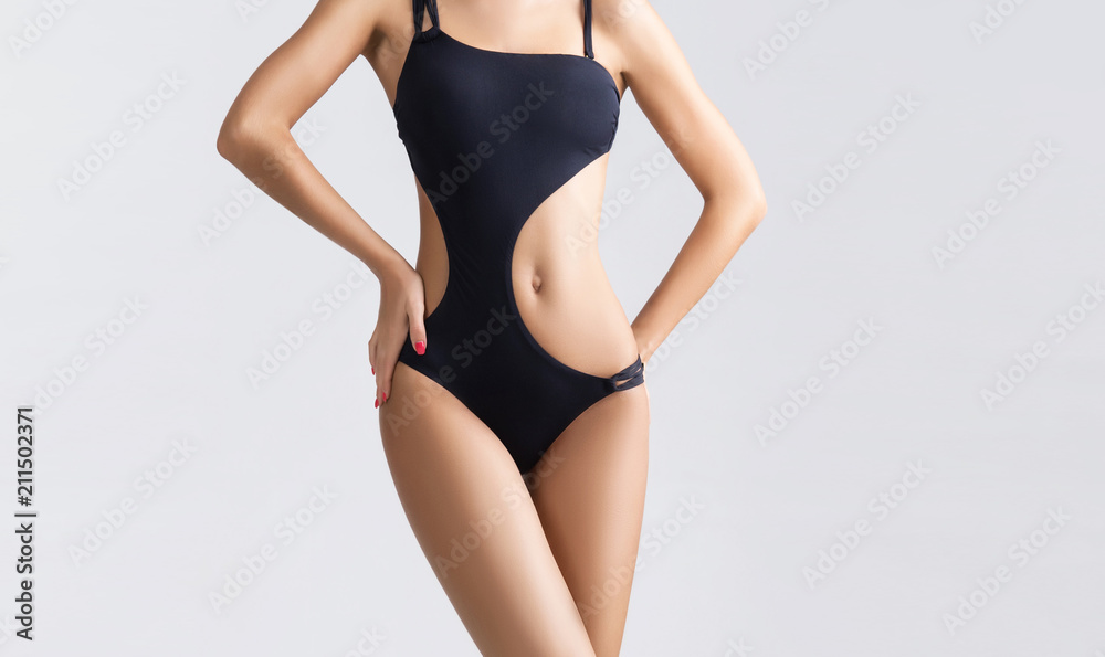 Obraz premium Slender and young girl with beautiful and fit body. Woman in swimsuit. Sport, diet, health and beauty concept.