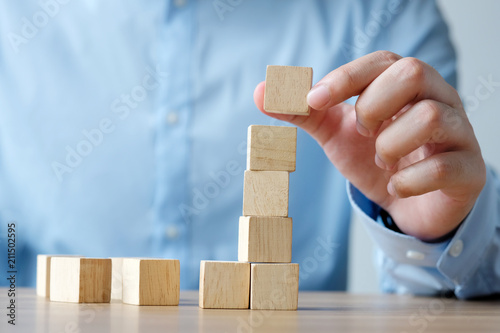 Hand holding blank wooden cubes, business concept background, mock up, template